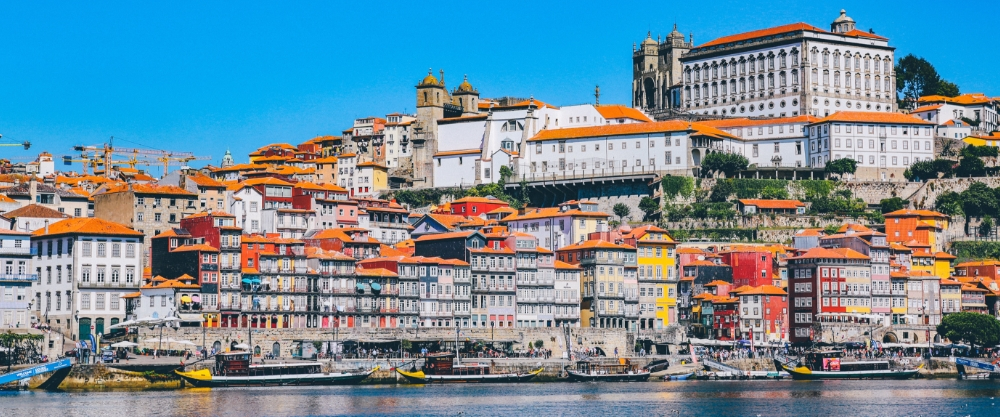 Panoramic view of Porto with its typical houses on the hill, the Douro River and the Castle at the top.
